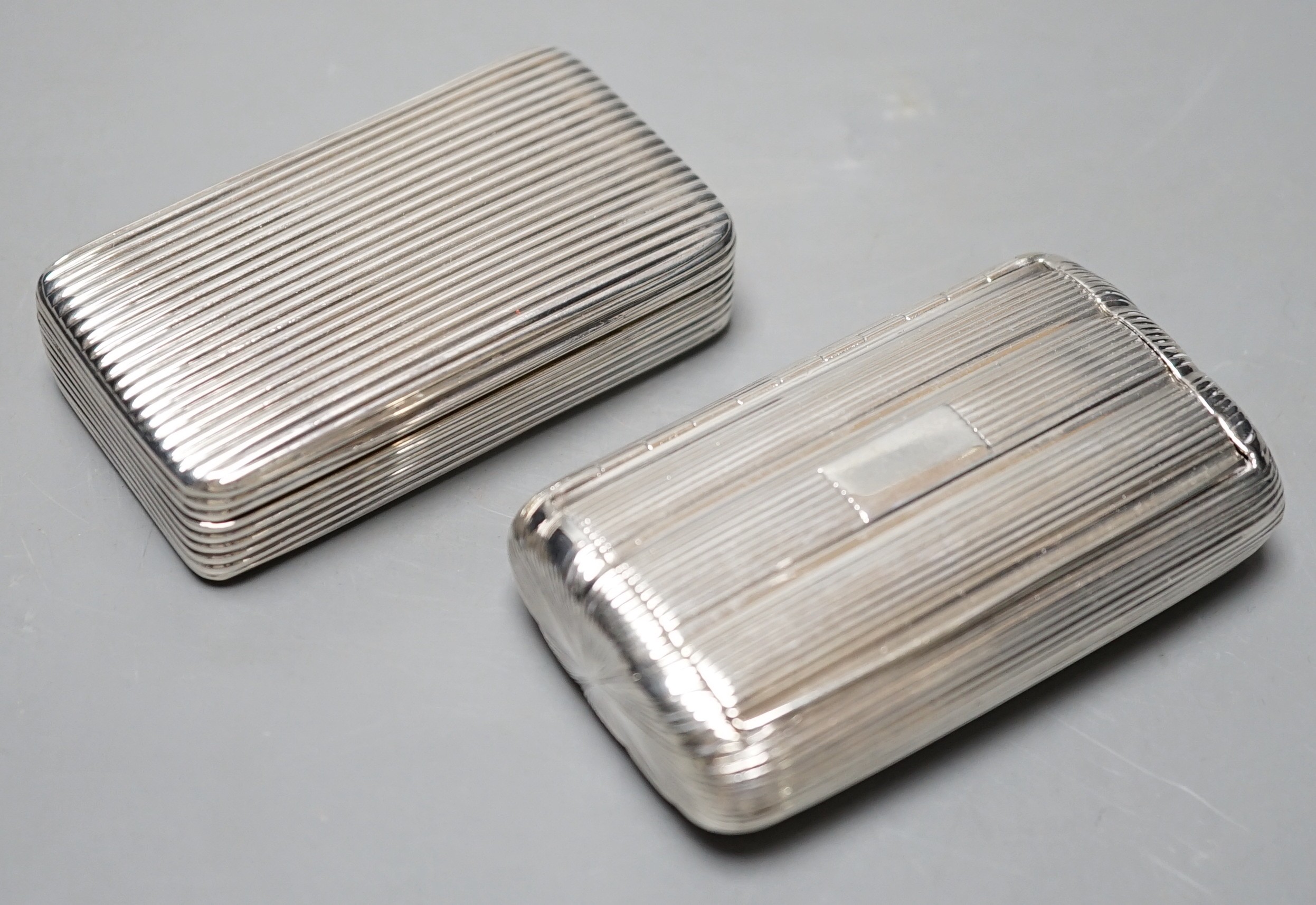 A George III ribbed silver snuff box, Londonm 1799, 72mm and one other similar later ovoid snuff box, TS, Birmingham, 1827.